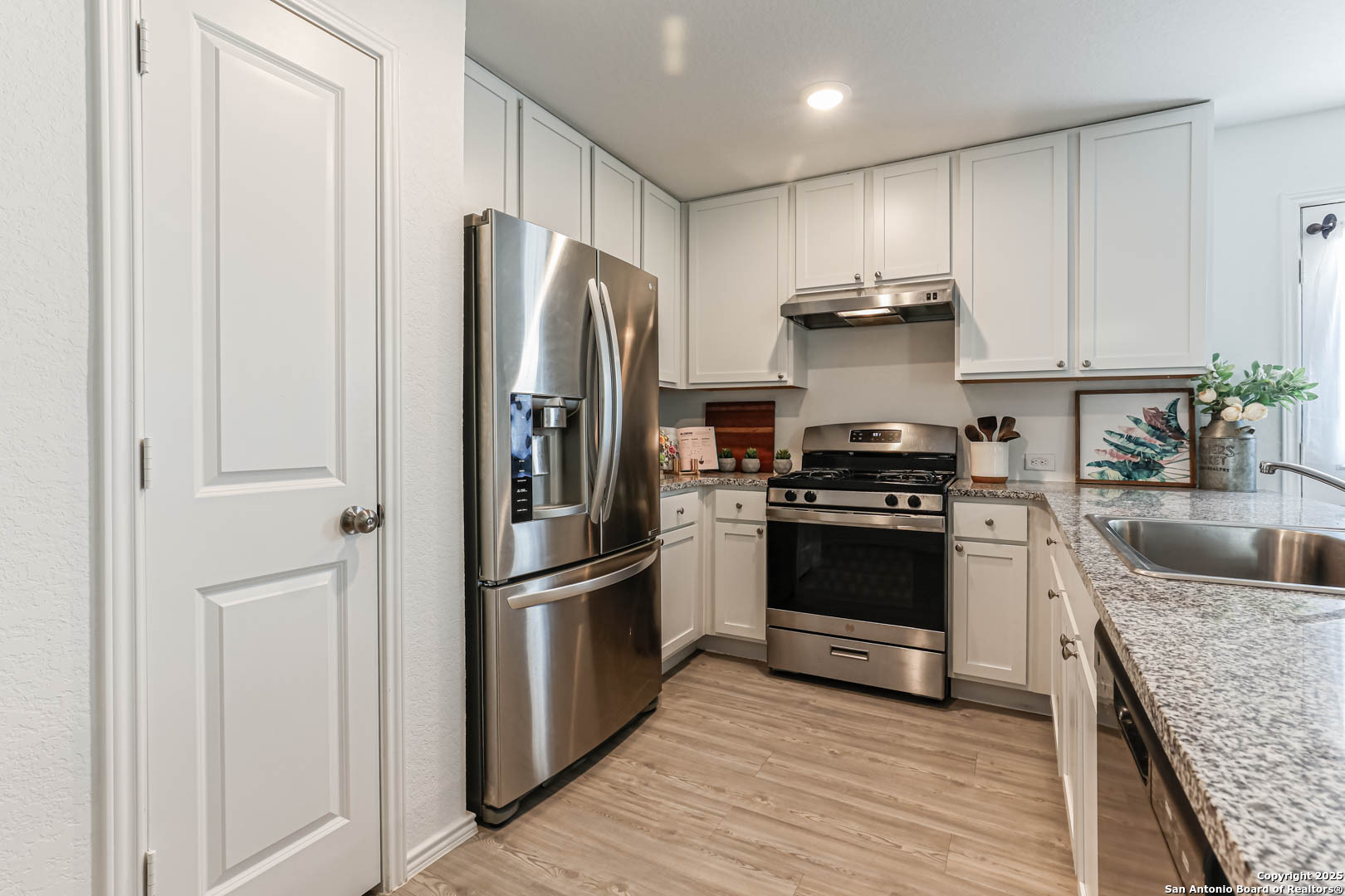 5935 Texas Seguin, TX 78155 - Photo 18 of 20 a kitchen with a refrigerator stove and sink