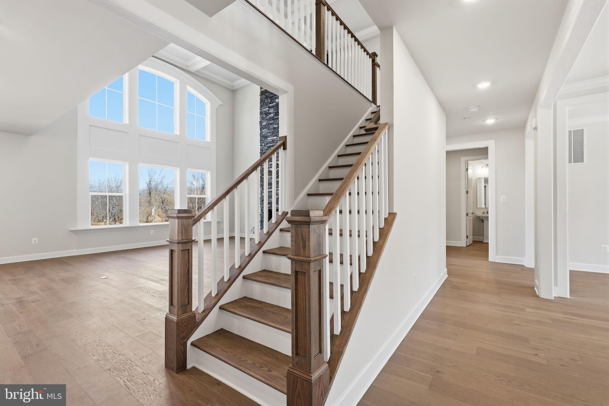 233 Coffman Drive Exton, PA 19341 - Photo 20 of 55 a view of staircase with wooden floor and a chandelier