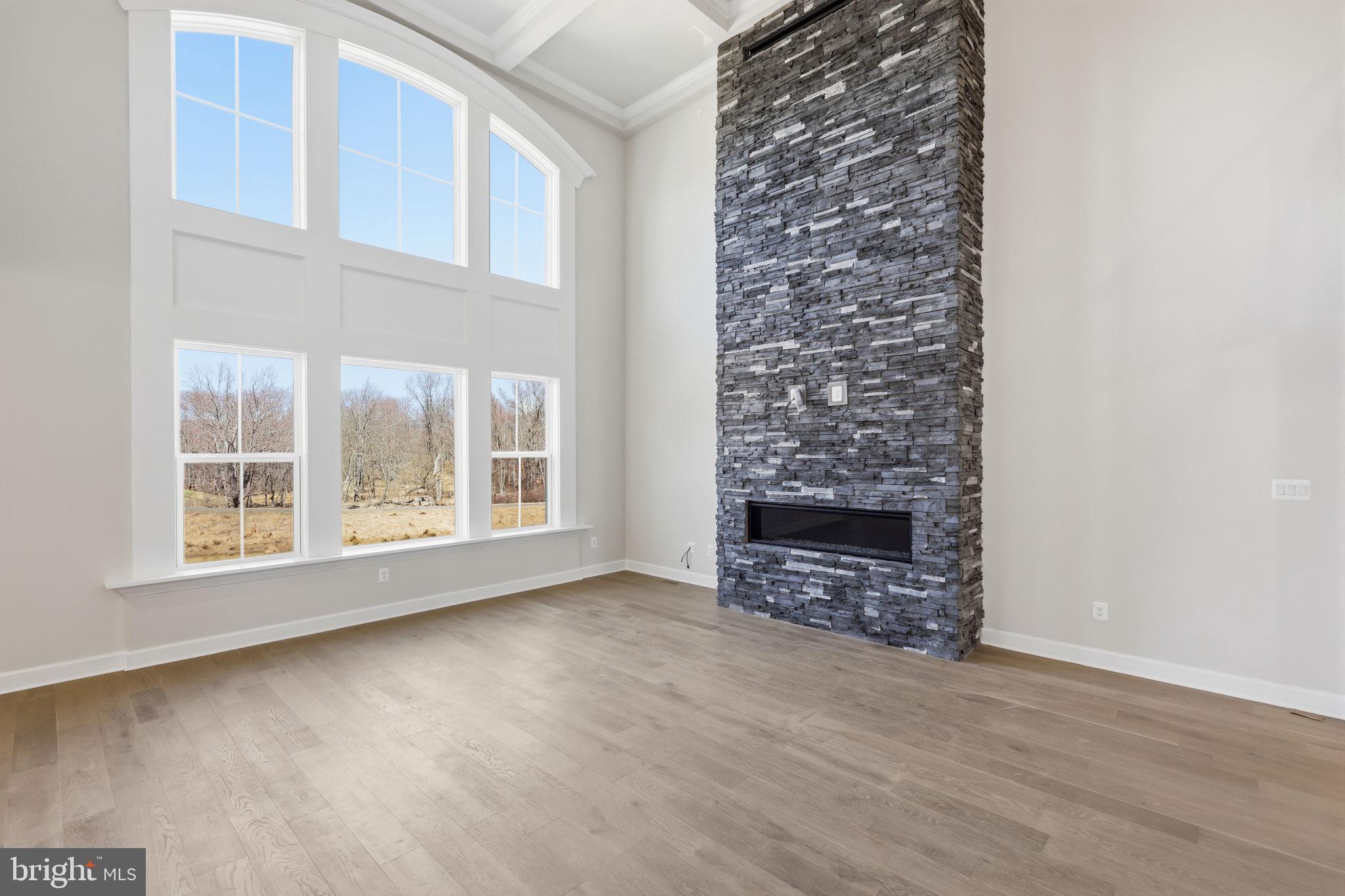 233 Coffman Drive Exton, PA 19341 - Photo 21 of 55 an empty room with a fireplace and windows