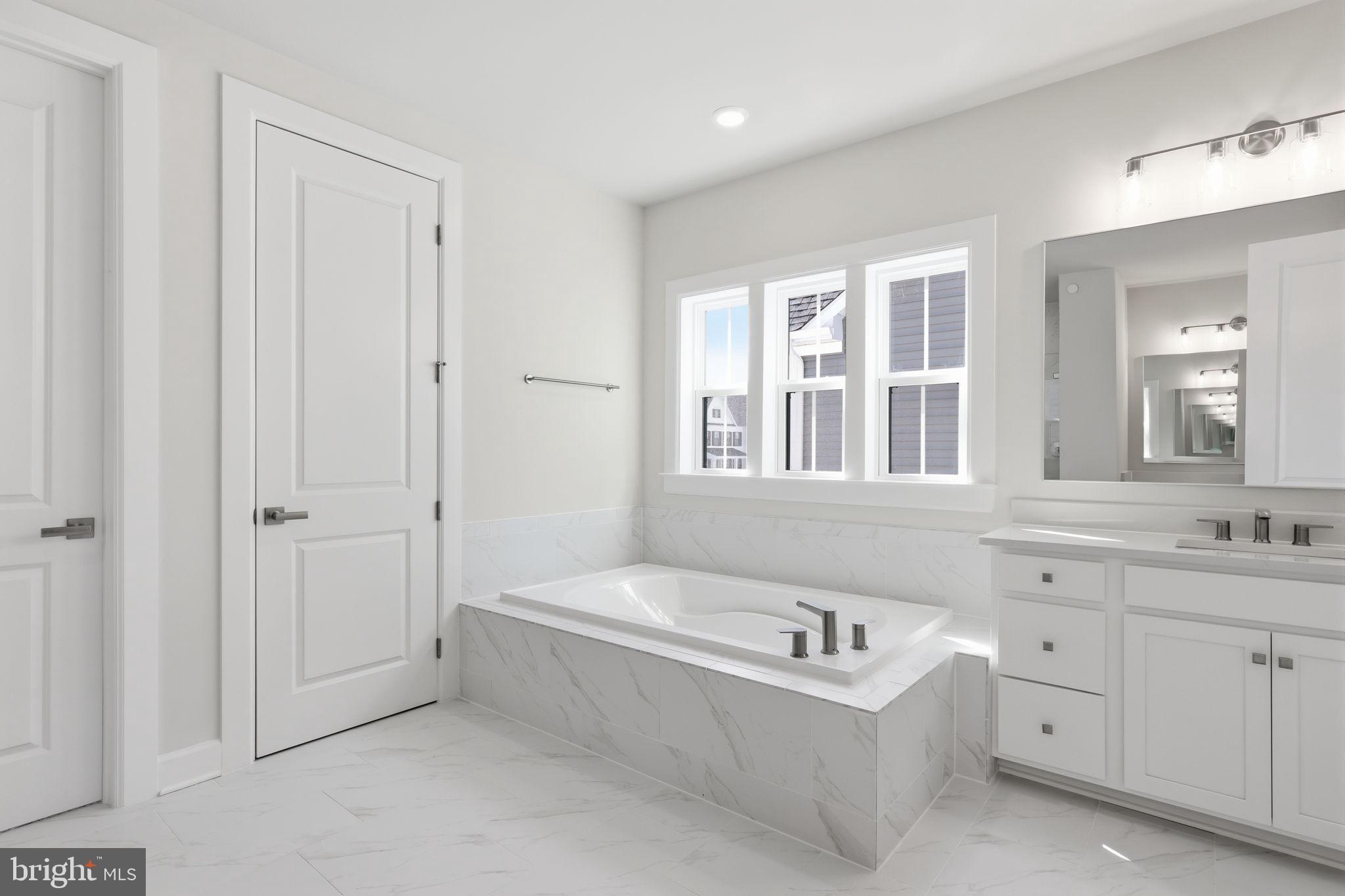 233 Coffman Drive Exton, PA 19341 - Photo 32 of 55 a bathroom with a tub sink and mirror