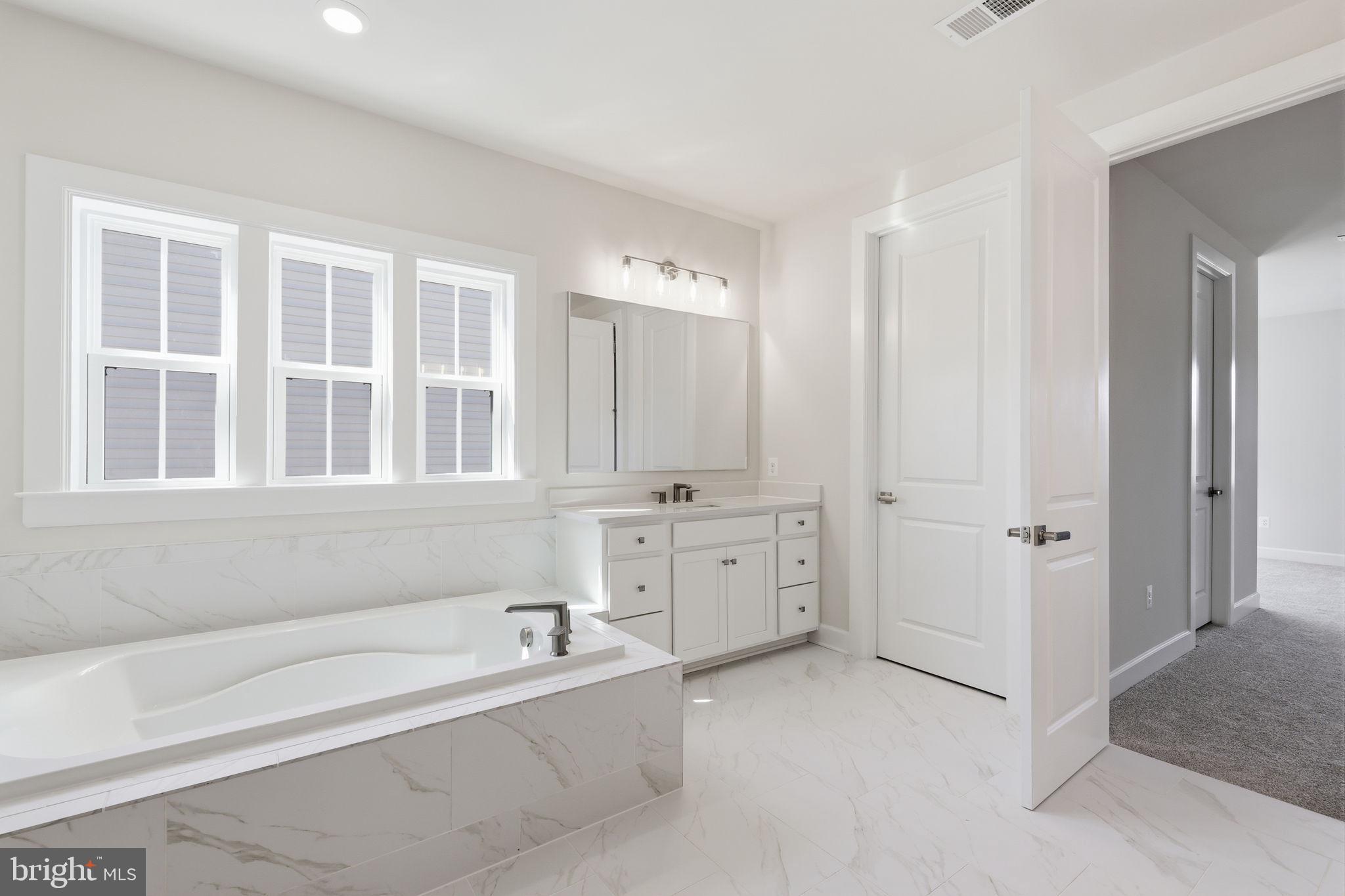 233 Coffman Drive Exton, PA 19341 - Photo 33 of 55 a spacious bathroom with a tub sink and mirror