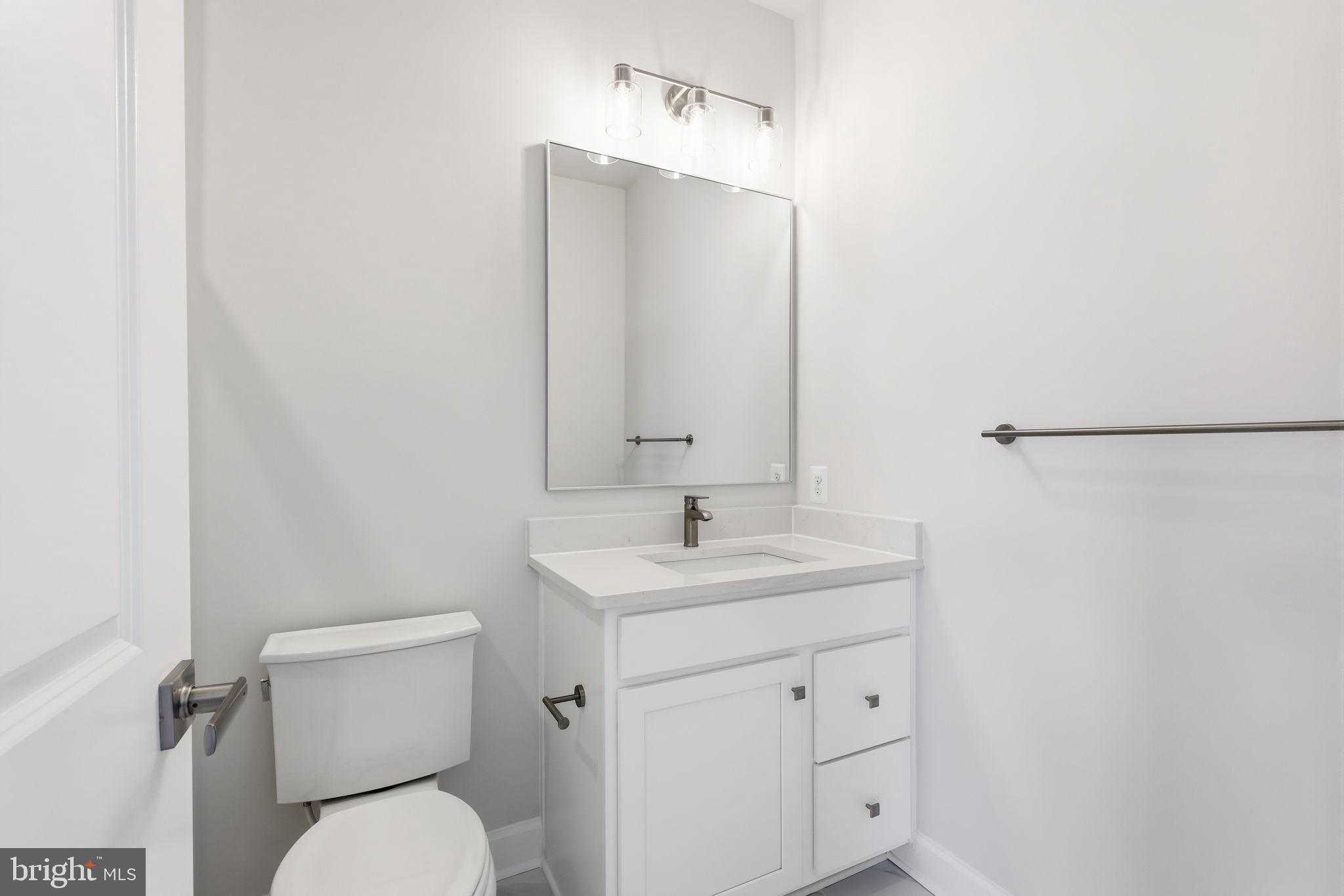 233 Coffman Drive Exton, PA 19341 - Photo 38 of 55 a bathroom with a toilet sink and mirror