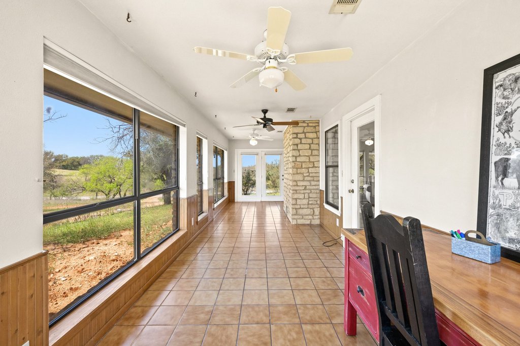3410 West Ranch Road 152 Llano, TX 78643 - Photo 22 of 36 Sunroom featuring french doors, wainscoting, tile patterned floors, and wood walls