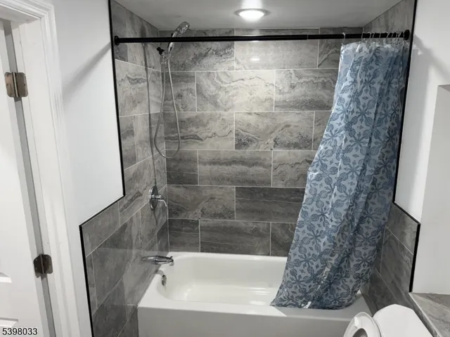 a bathroom with a shower and a toilet sink