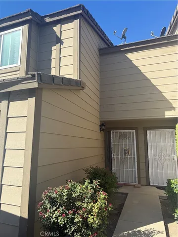 a view of a house with a flower garden