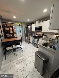 a bathroom with a sink mirror and cabinets
