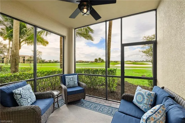 a living room with a couch and a floor to ceiling window
