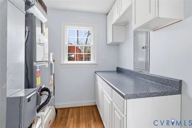 a kitchen with granite countertop a sink stove and refrigerator