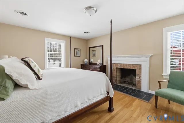 a bedroom with a bed and a flat tv screen on the dresser