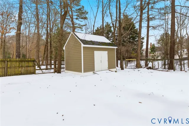 a view of swimming pool with trees and wooden fence