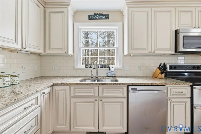 a kitchen with granite countertop white cabinets and white appliances
