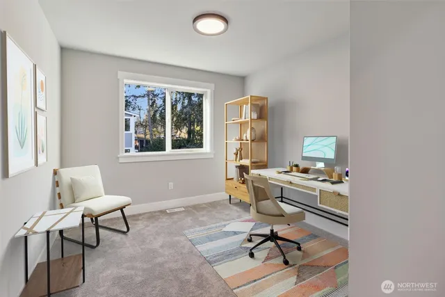 a view of a workspace with furniture and a window