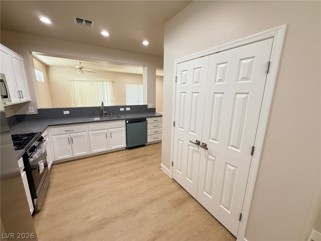 3036 Fort Stanwix Road Henderson, NV 89052 - Photo 4 of 18 Clean lines and smooth vinyl flooring define this functional workspace showing pass-through visibility.