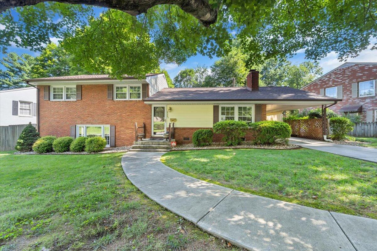 2736 Beverly Boulevard Southwest Roanoke, VA 24015 - Photo 2 of 41 a front view of a house with a yard and potted plants