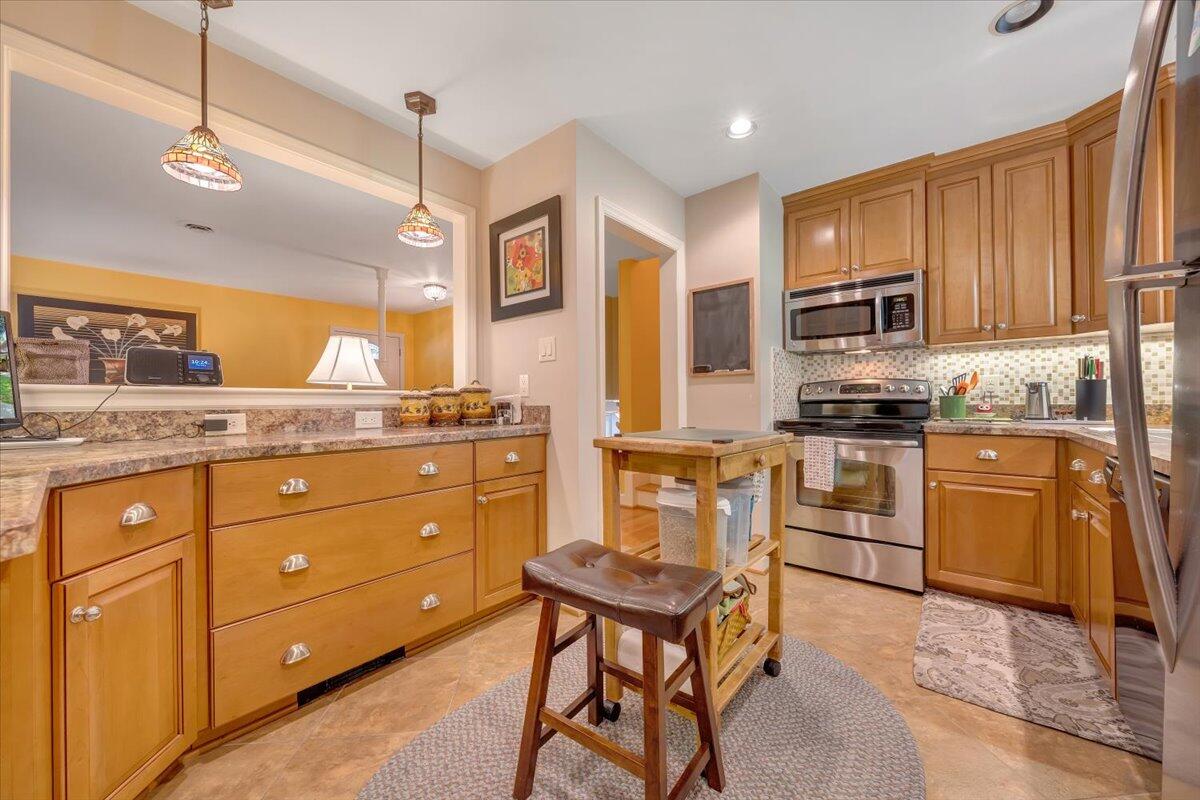 2736 Beverly Boulevard Southwest Roanoke, VA 24015 - Photo 22 of 41 a kitchen with stainless steel appliances kitchen island granite countertop a stove a sink and a refrigerator
