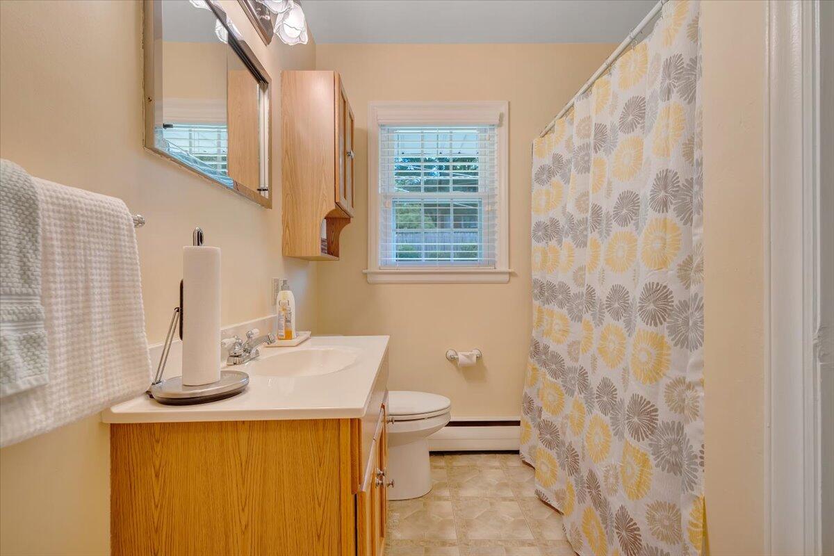 2736 Beverly Boulevard Southwest Roanoke, VA 24015 - Photo 25 of 41 a bathroom with a sink a toilet and shower curtain