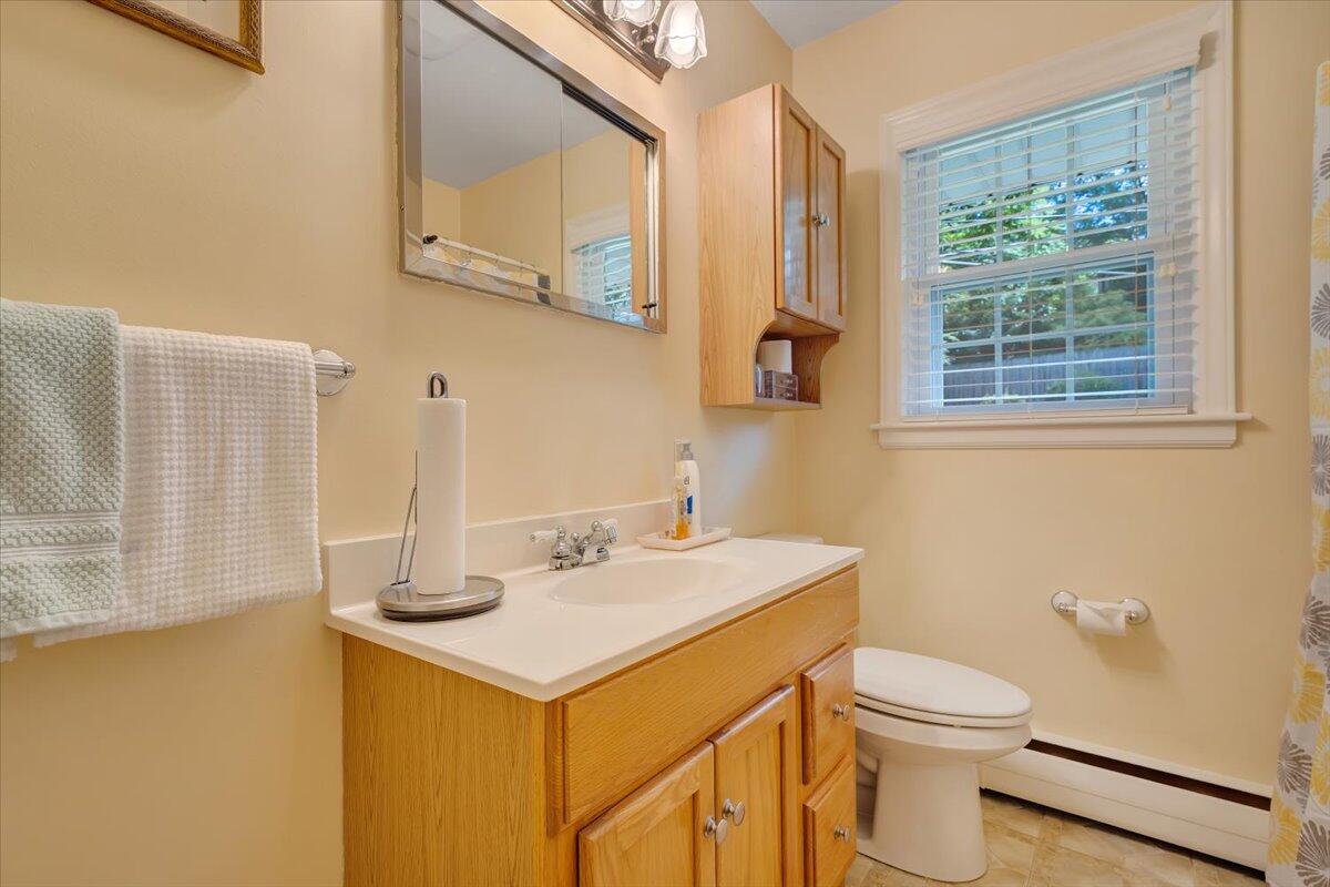 2736 Beverly Boulevard Southwest Roanoke, VA 24015 - Photo 27 of 41 a bathroom with a sink a toilet and a mirror