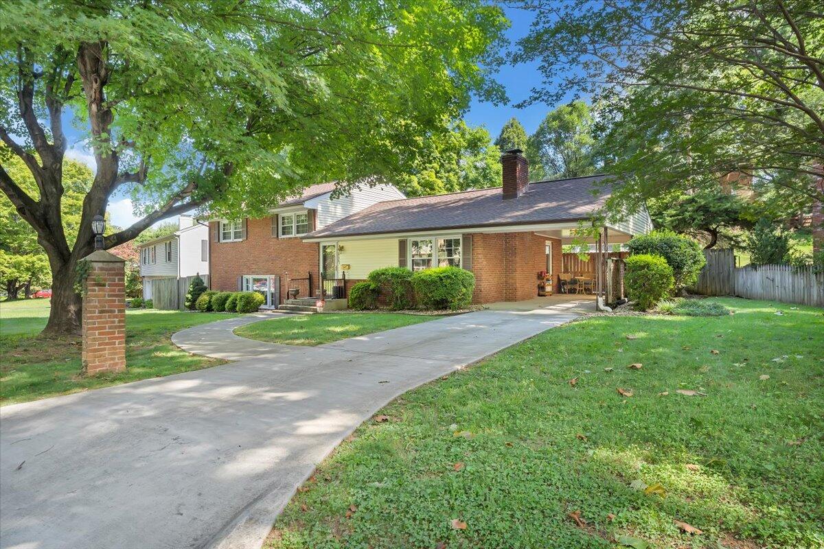 2736 Beverly Boulevard Southwest Roanoke, VA 24015 - Photo 3 of 41 a view of a house next to a big yard and large trees