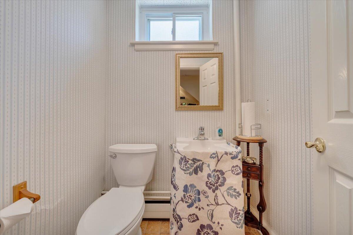 2736 Beverly Boulevard Southwest Roanoke, VA 24015 - Photo 39 of 41 a bathroom with a toilet a sink and a mirror