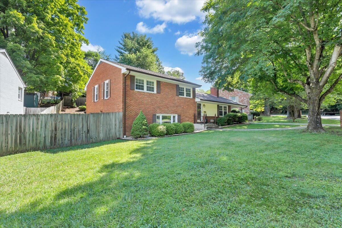 2736 Beverly Boulevard Southwest Roanoke, VA 24015 - Photo 6 of 41 a front view of a house with a garden and trees