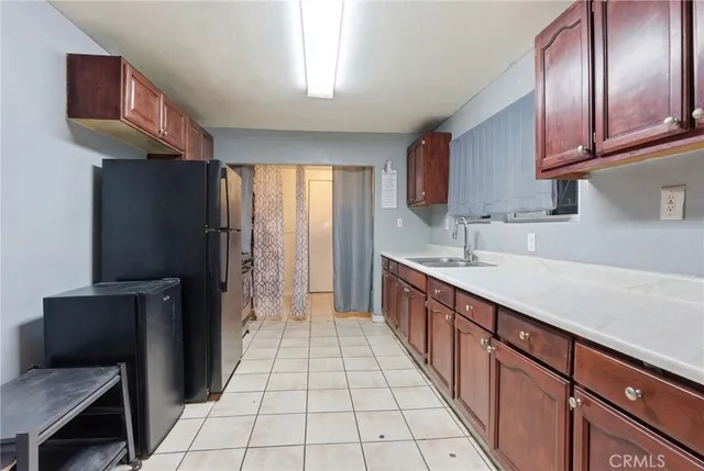 a kitchen with a sink dishwasher stove and cabinets