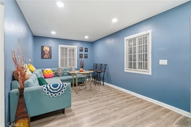 a living room with furniture and a wooden floor