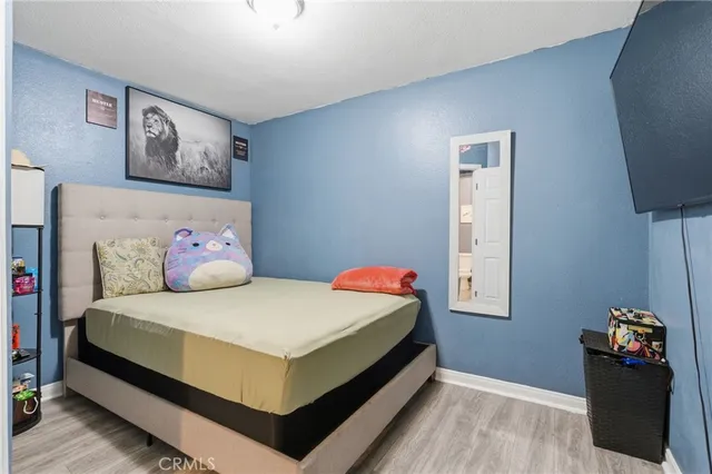 a view of a kitchen with refrigerator and wooden floor
