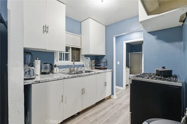 a view of kitchen with furniture and wooden floor