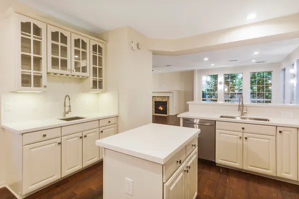 a kitchen with a sink stove and cabinets