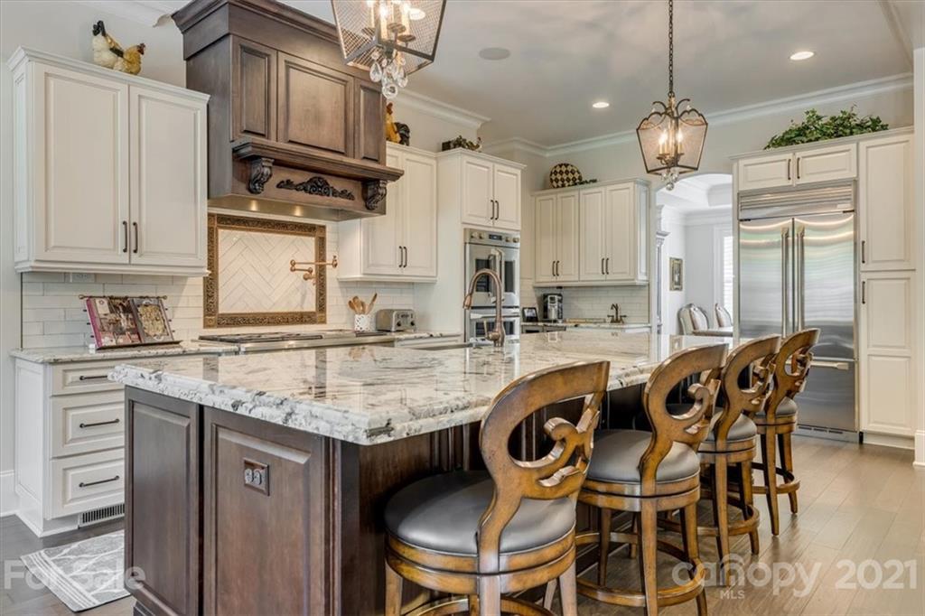 2886 Holbrook Road Fort Mill, SC 29715 - Photo 7 of 34 a kitchen with a dining table chairs sink and cabinets