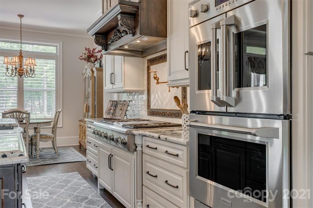 2886 Holbrook Road Fort Mill, SC 29715 - Photo 8 of 34 a kitchen with stainless steel appliances granite countertop a stove and a white cabinets