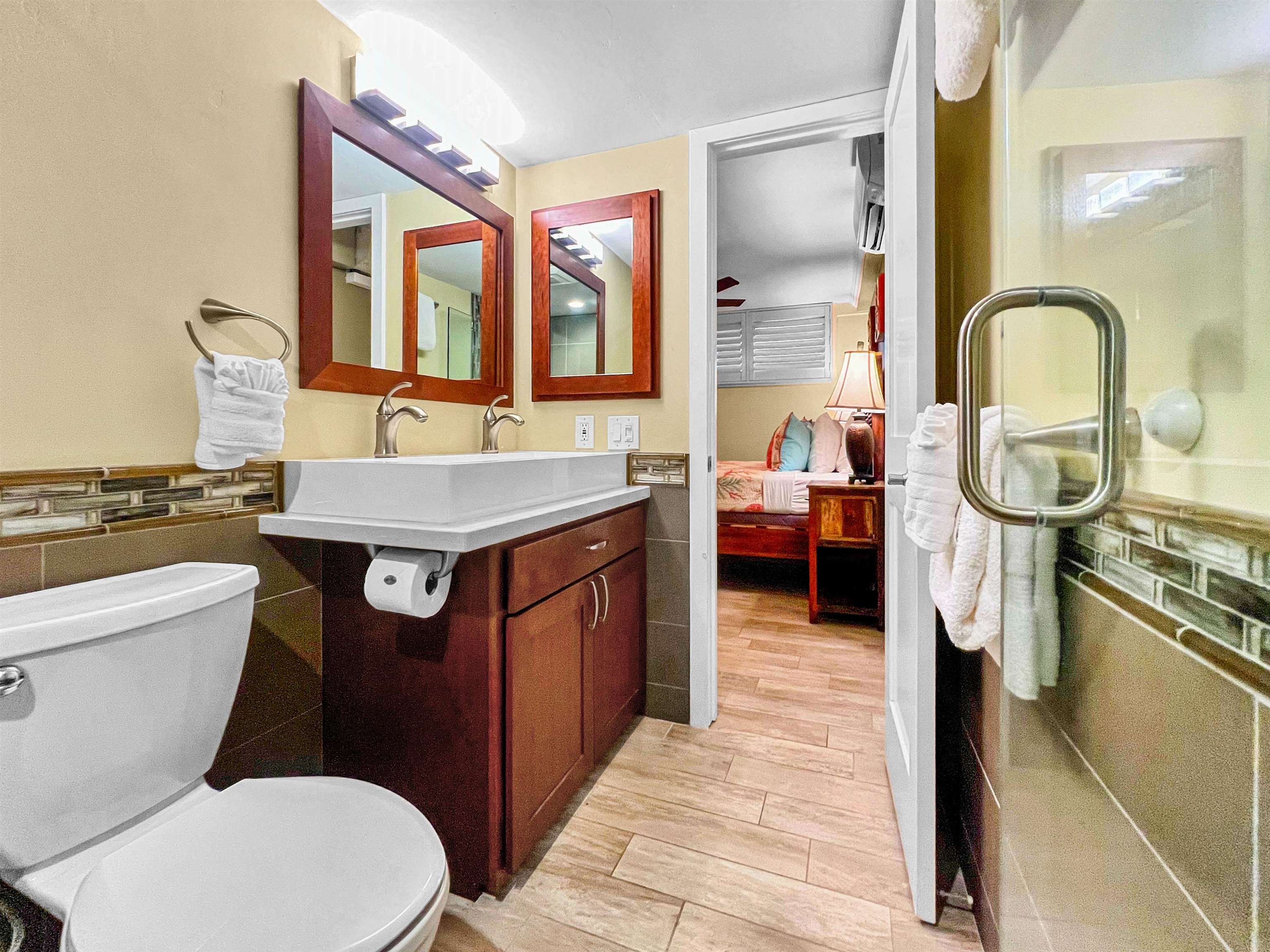 2936 South Kihei Road, Unit 512 Kihei, HI 96753 - Photo 13 of 20 a bathroom with a sink a toilet and a mirror