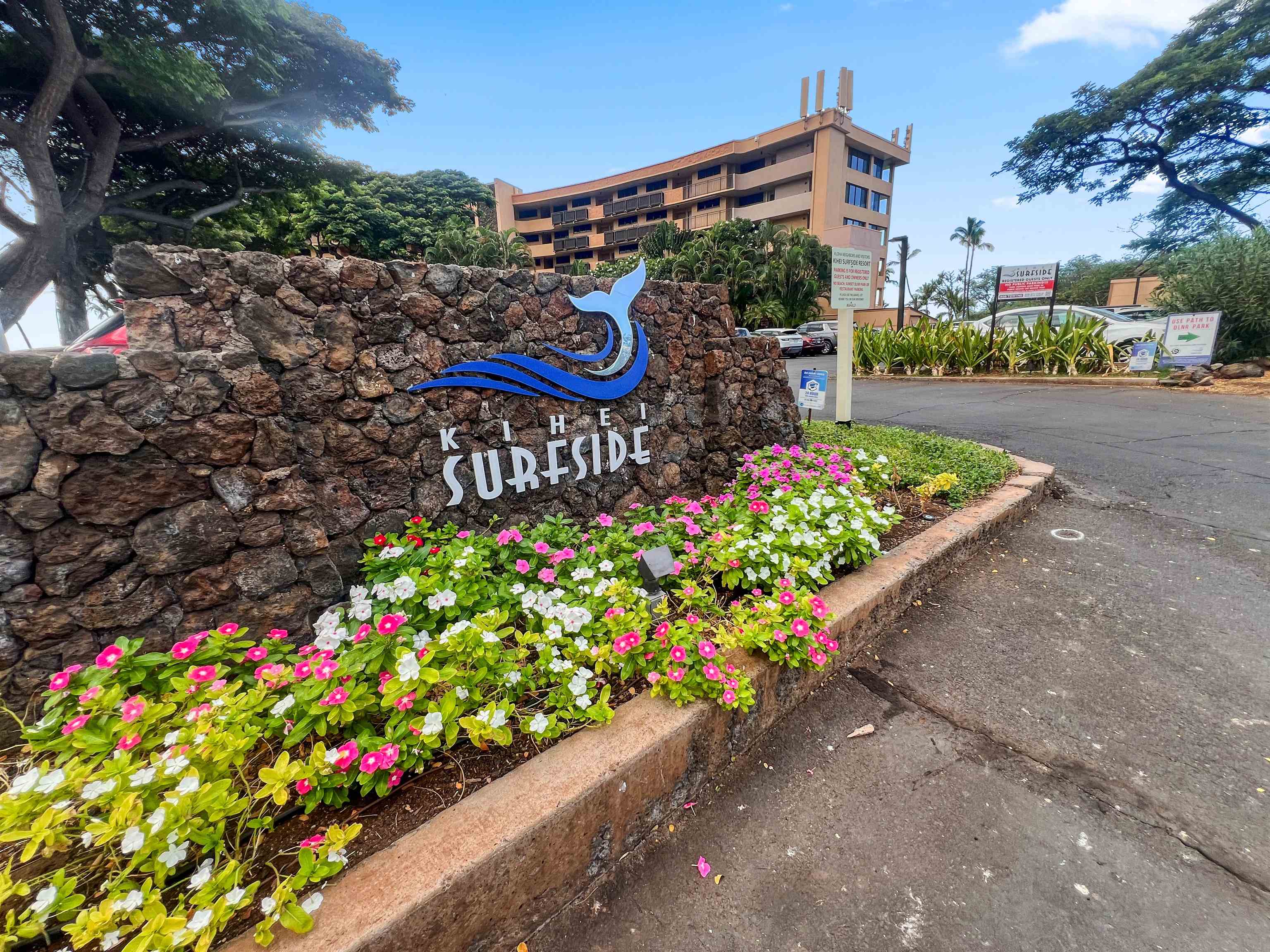 2936 South Kihei Road, Unit 512 Kihei, HI 96753 - Photo 17 of 20 a sign that is in front of flowers