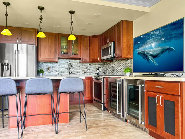 a kitchen with stainless steel appliances granite countertop a stove a sink and a wooden cabinets