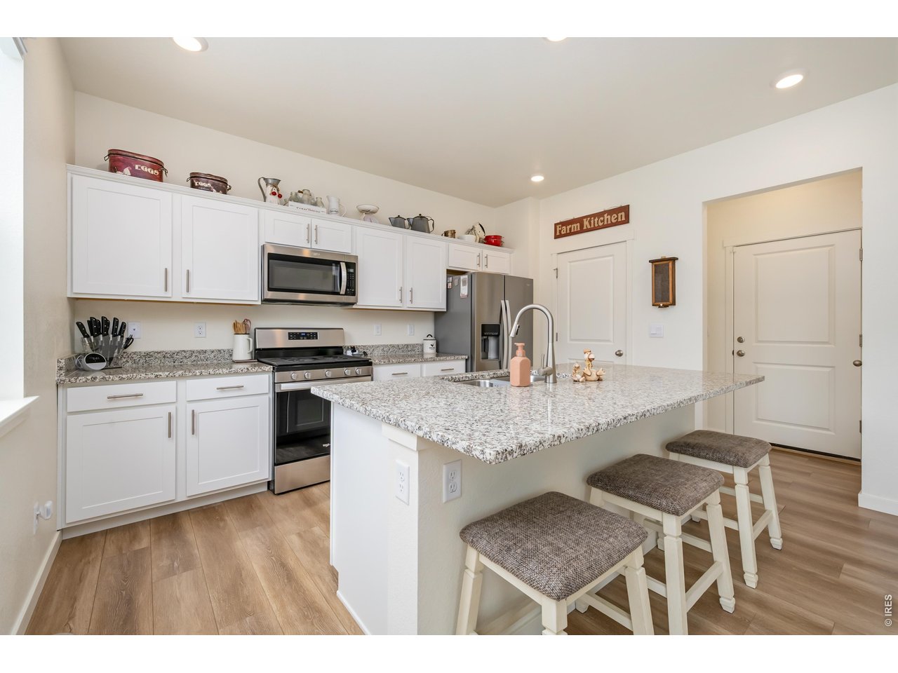 352 Bluebird Road Johnstown, CO 80534 - Photo 10 of 26 Bright airy kitchen with granite counters and gas range with convection/air fry oven