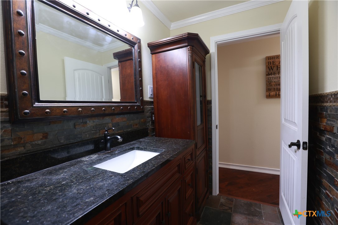 2706 Bowie Trail Temple, TX 76502 - Photo 19 of 25 a bathroom with a granite countertop sink and a mirror