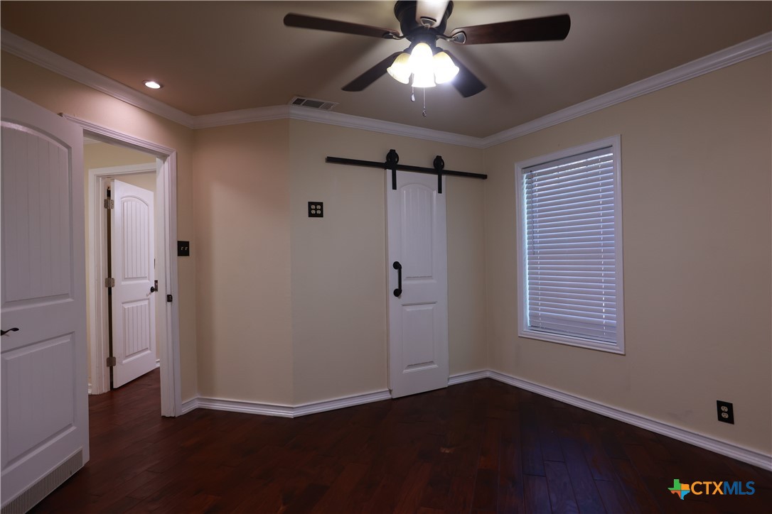 2706 Bowie Trail Temple, TX 76502 - Photo 3 of 25 a view of an empty room with wooden floor and a window