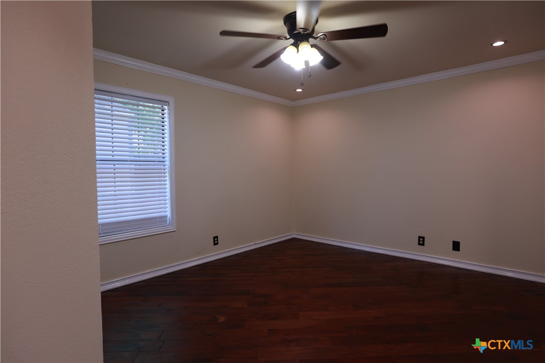 2706 Bowie Trail Temple, TX 76502 - Photo 4 of 25 an empty room with a window and ceiling fan