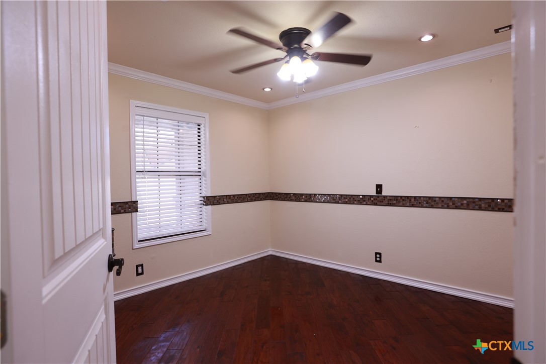 2706 Bowie Trail Temple, TX 76502 - Photo 10 of 25 wooden floor in an empty room with a window