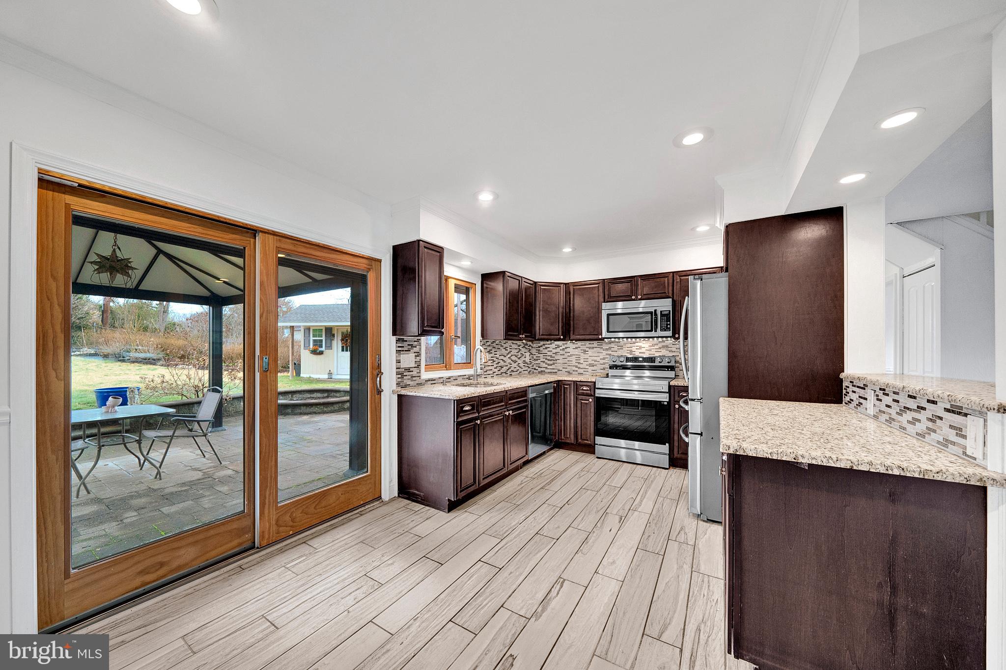 6 Unity Turn Levittown, PA 19056 - Photo 11 of 50 a large kitchen with a large counter top appliances and cabinets