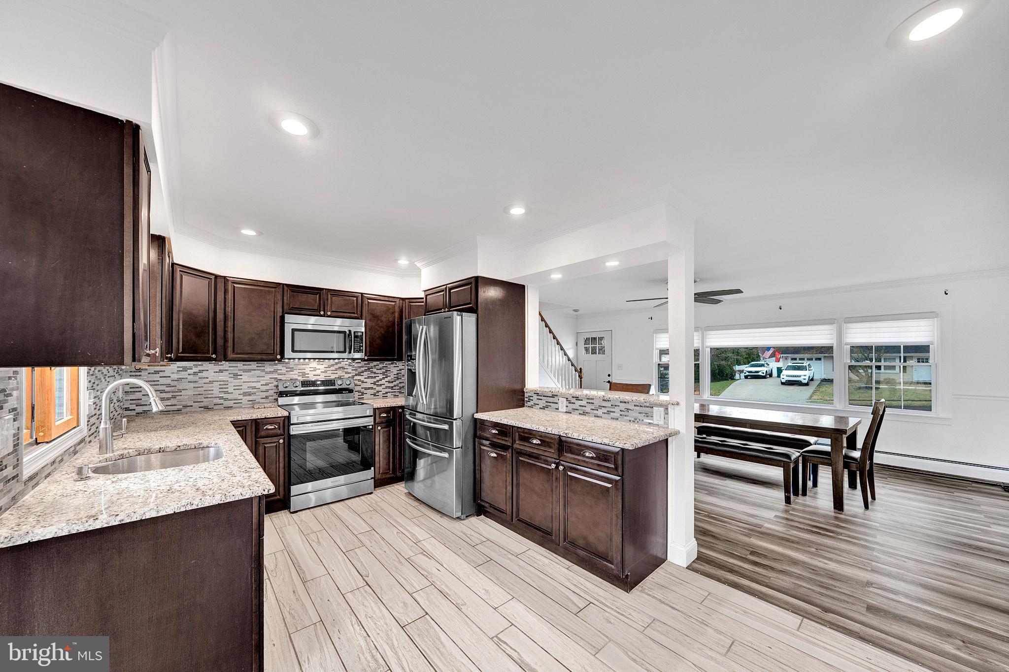 6 Unity Turn Levittown, PA 19056 - Photo 12 of 50 a kitchen with stainless steel appliances kitchen island granite countertop a sink stove and refrigerator
