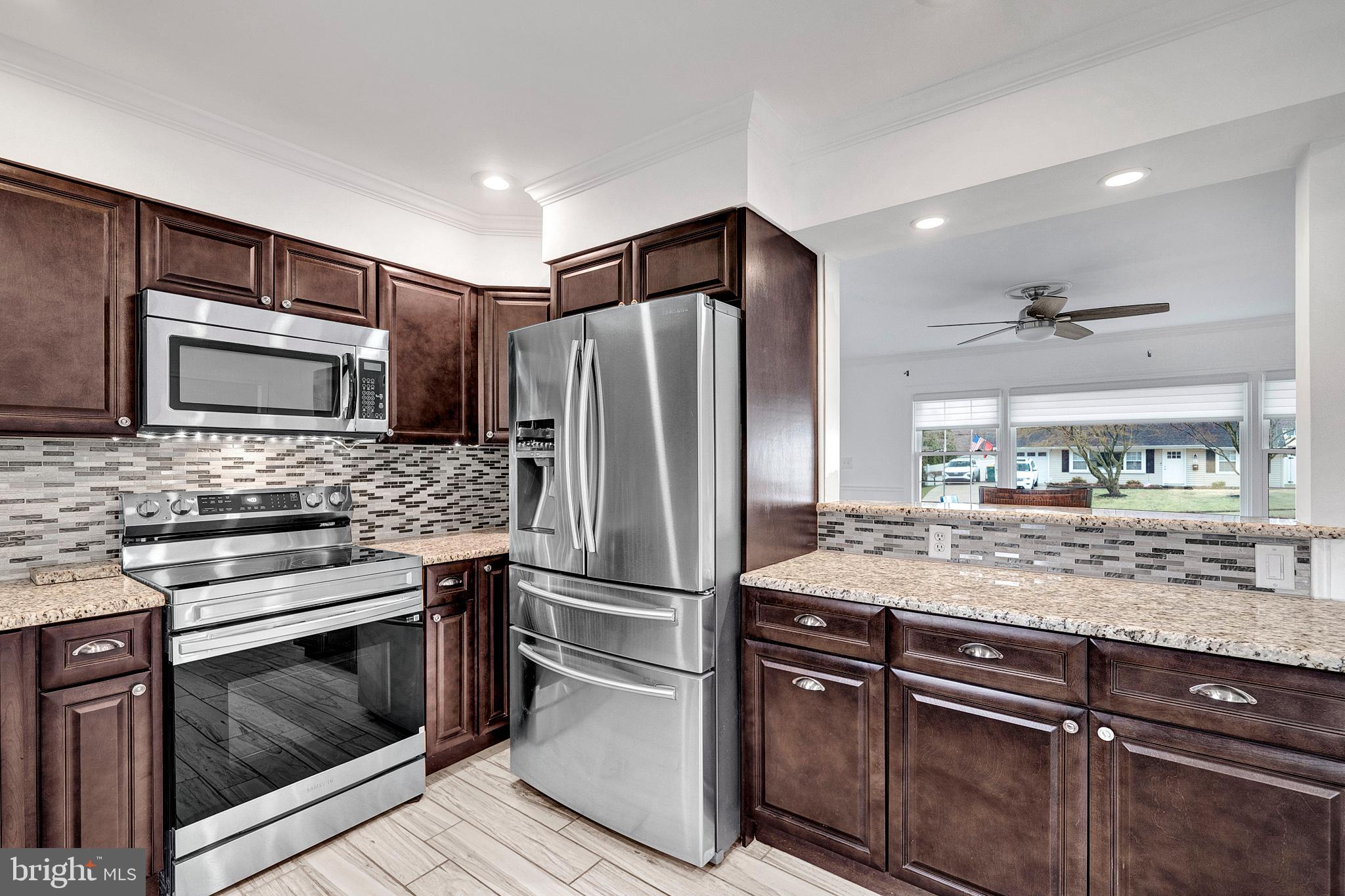6 Unity Turn Levittown, PA 19056 - Photo 14 of 50 a kitchen with kitchen island granite countertop stainless steel appliances and counter space
