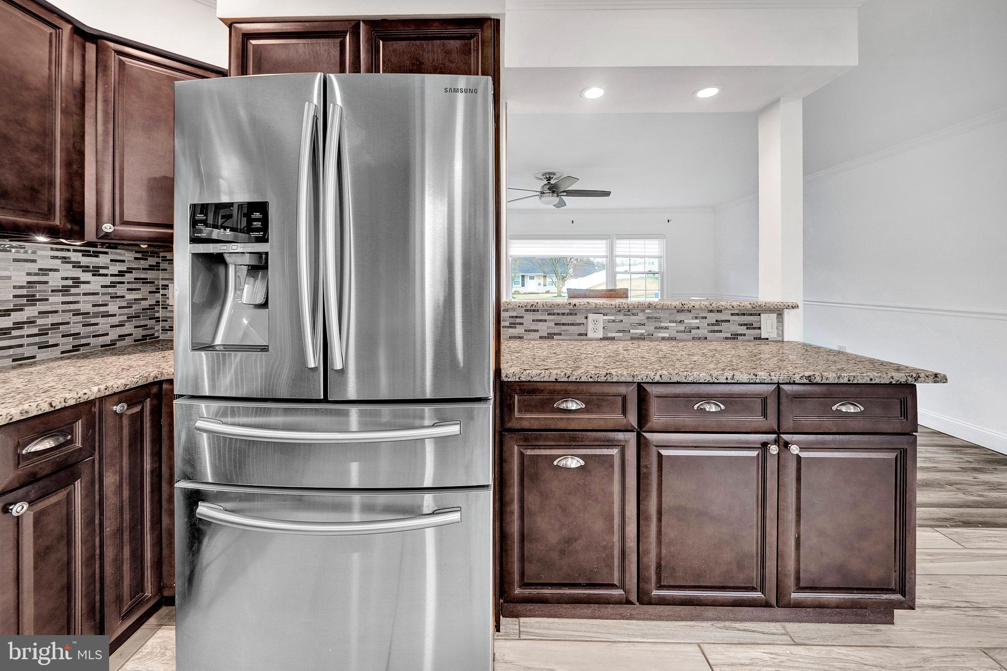 6 Unity Turn Levittown, PA 19056 - Photo 15 of 50 a kitchen with kitchen island granite countertop a refrigerator and a sink