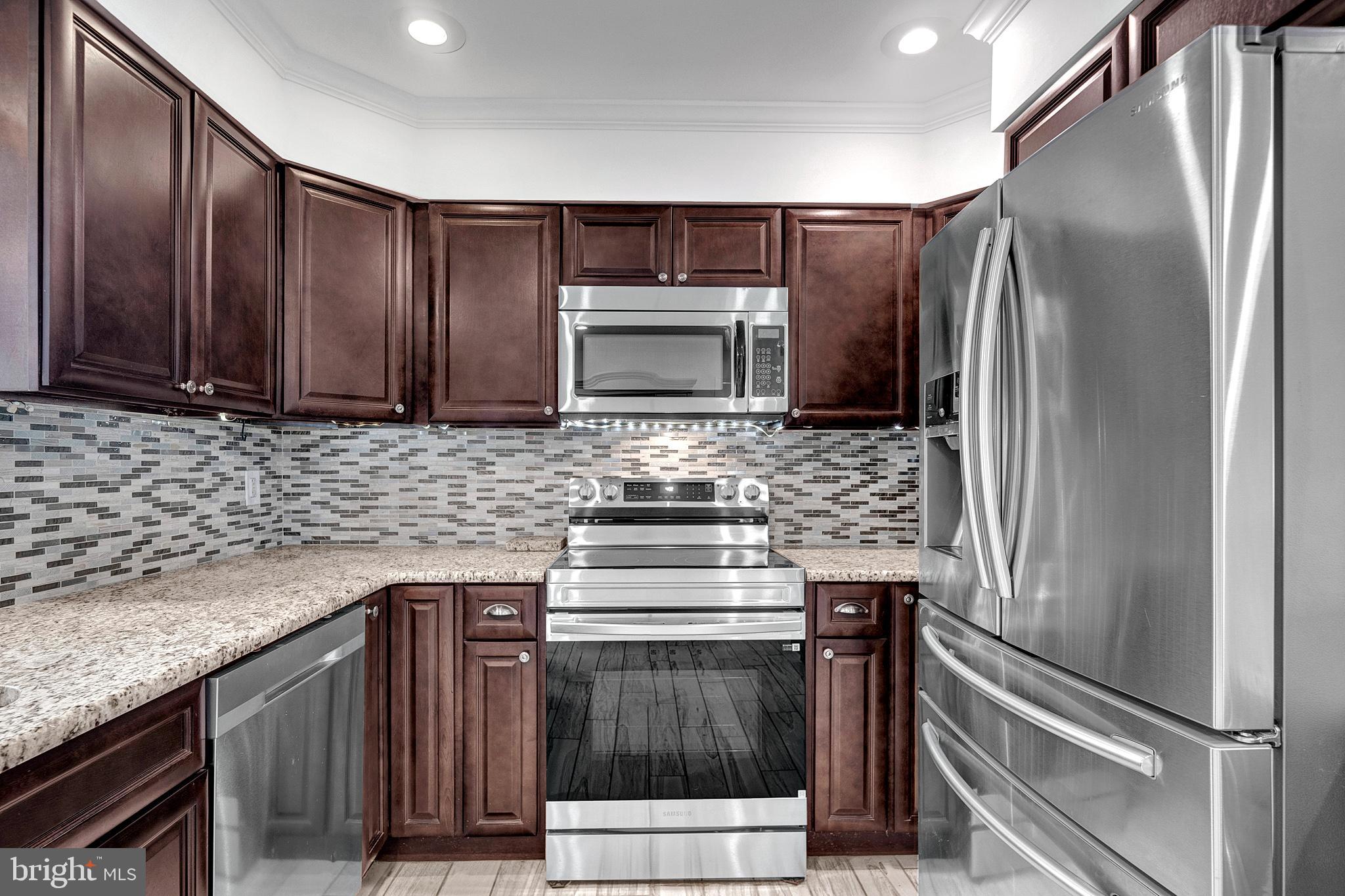 6 Unity Turn Levittown, PA 19056 - Photo 16 of 50 a kitchen with granite countertop a stove and a refrigerator