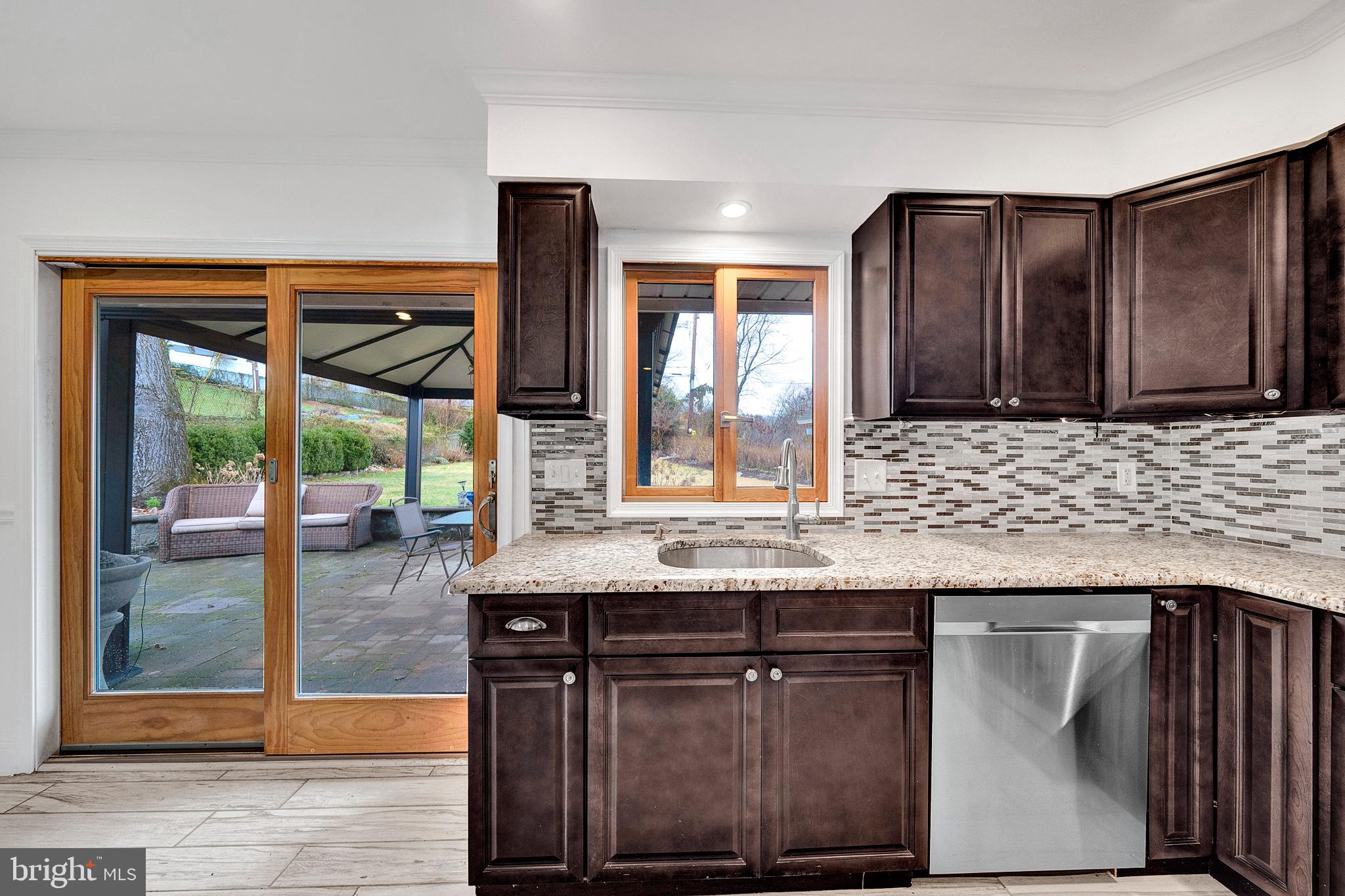 6 Unity Turn Levittown, PA 19056 - Photo 17 of 50 a kitchen with granite countertop a sink and wooden cabinets