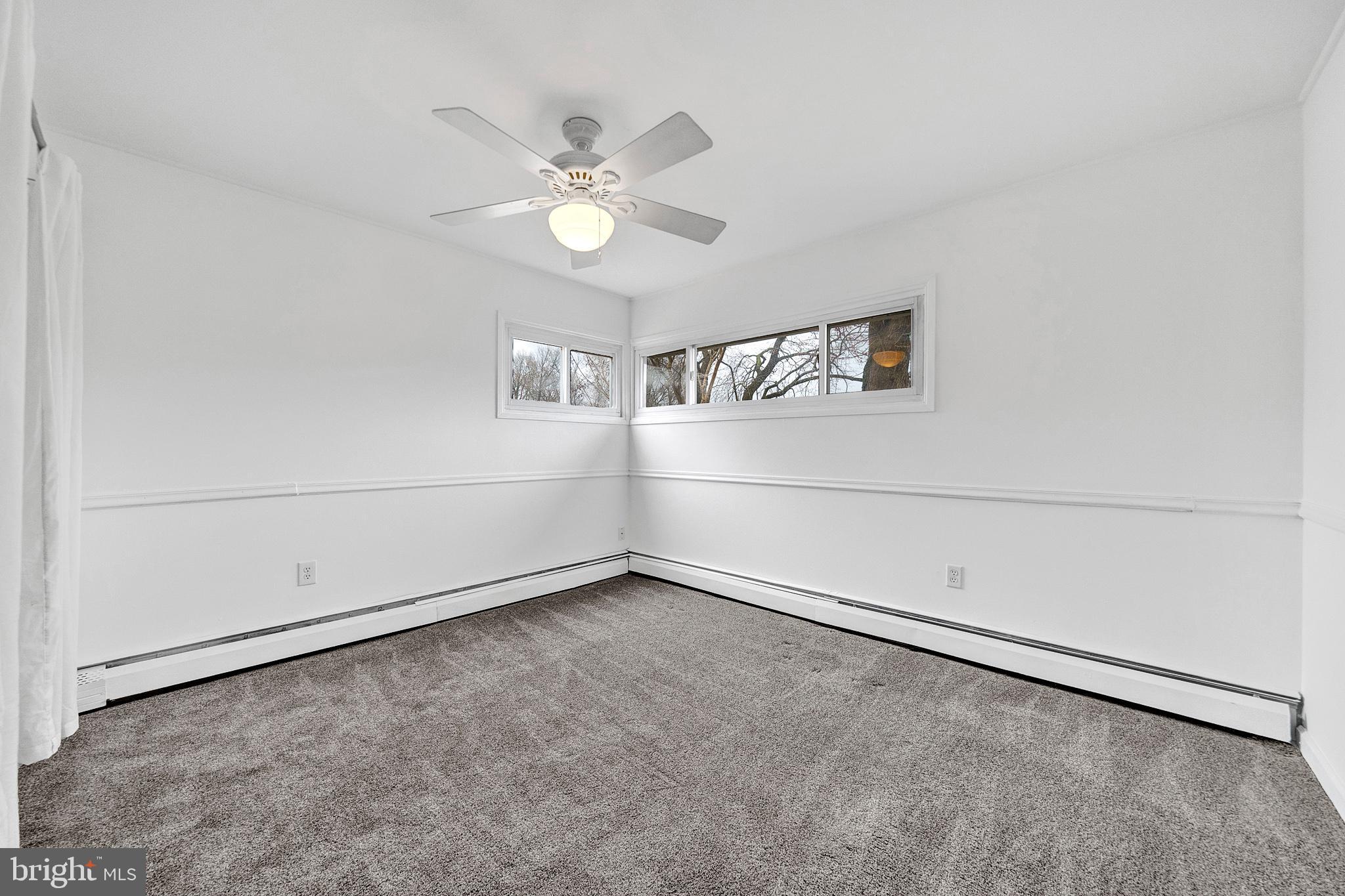 6 Unity Turn Levittown, PA 19056 - Photo 24 of 50 an empty room with windows and fan