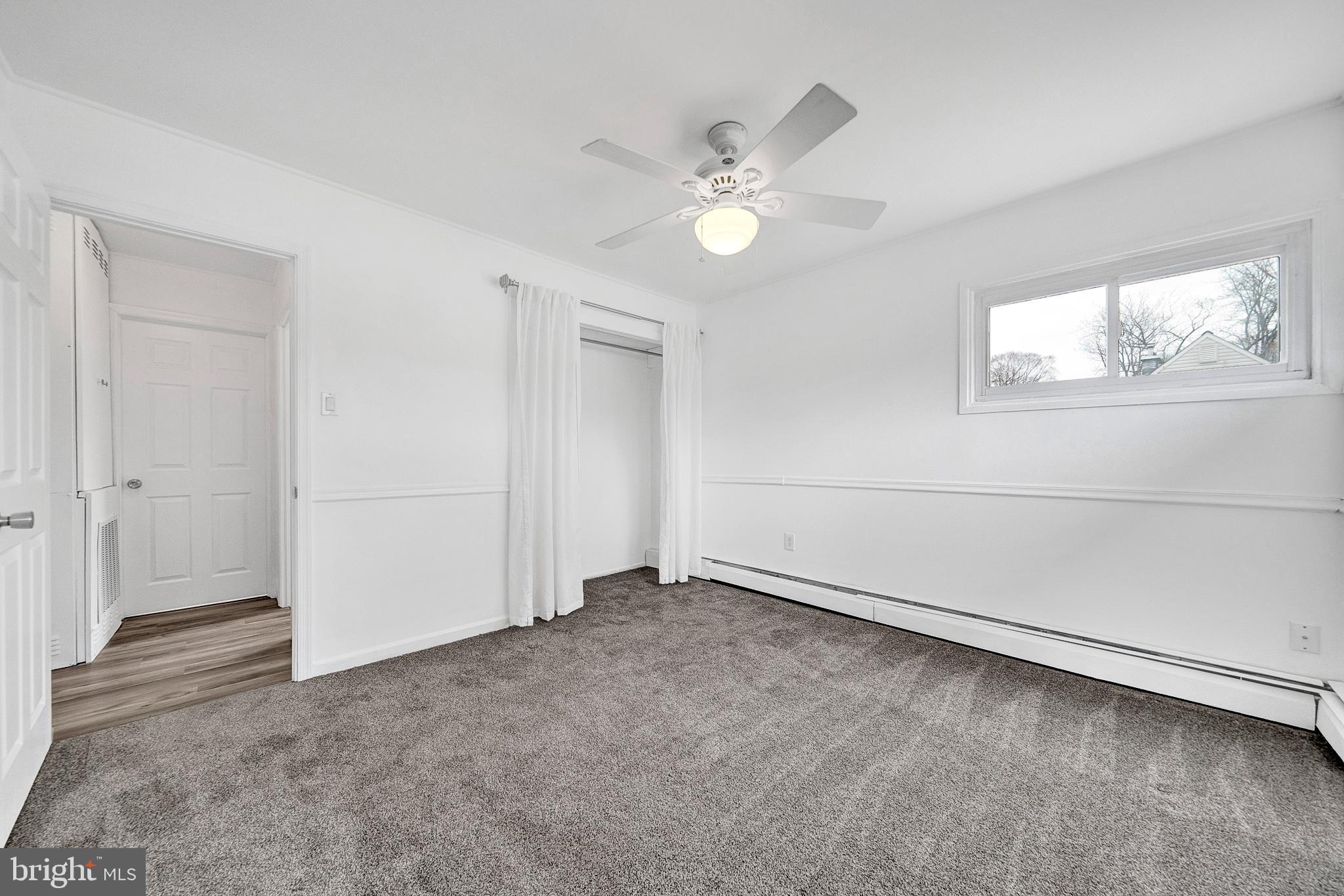 6 Unity Turn Levittown, PA 19056 - Photo 25 of 50 an empty room with windows and fan