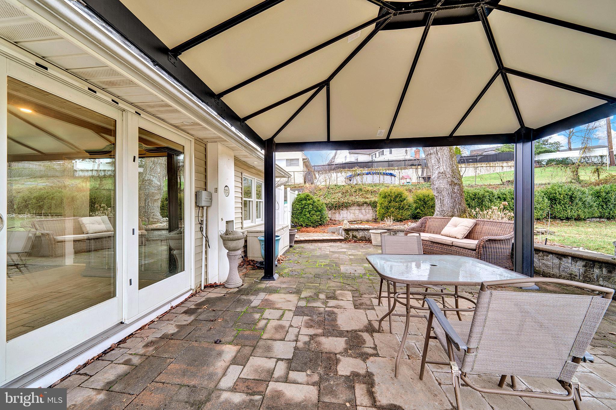 6 Unity Turn Levittown, PA 19056 - Photo 40 of 50 a view of patio with a table and chairs under an umbrella