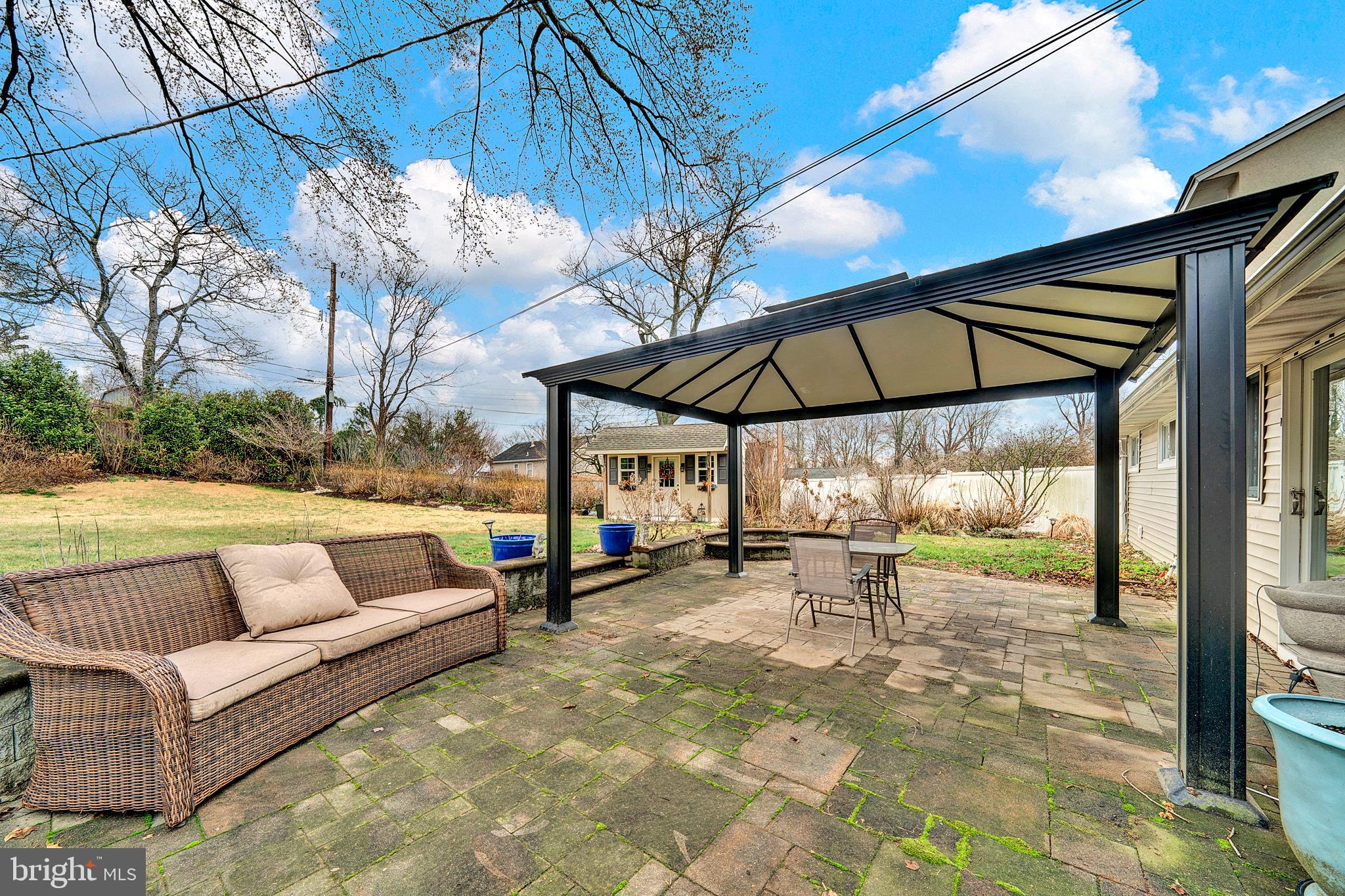 6 Unity Turn Levittown, PA 19056 - Photo 41 of 50 a view of a patio with a table and chairs under an umbrella