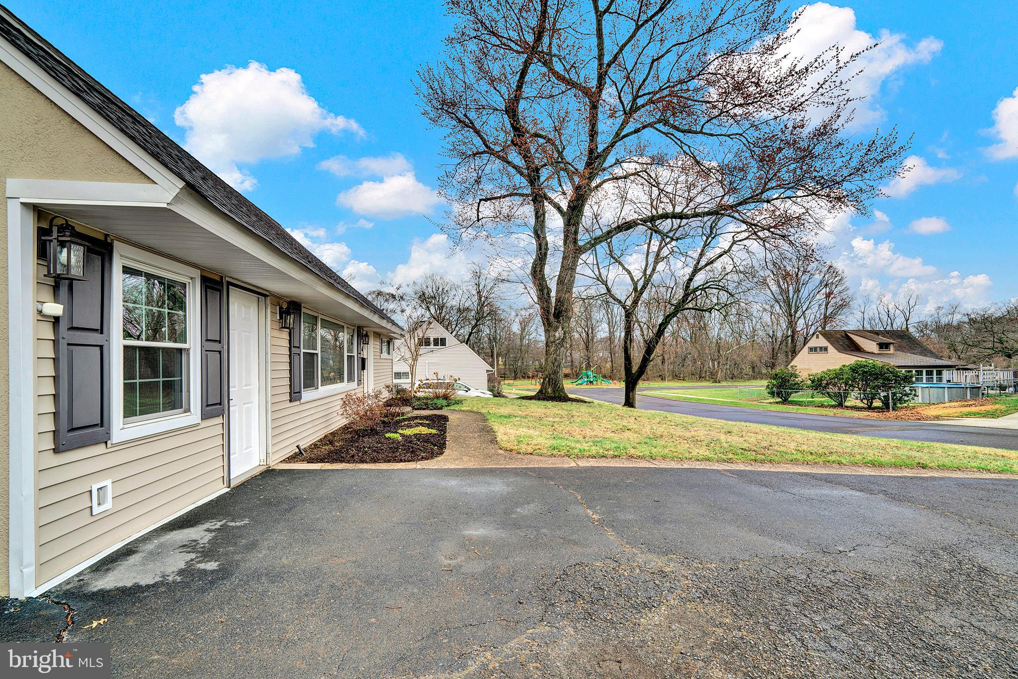 6 Unity Turn Levittown, PA 19056 - Photo 6 of 50 a view of a house with large trees and a yard
